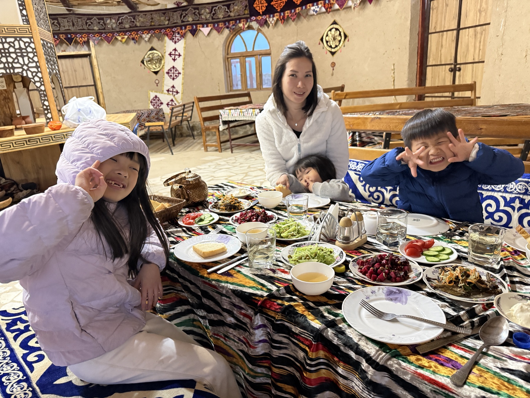 Family sharing dinner at the yurt camp