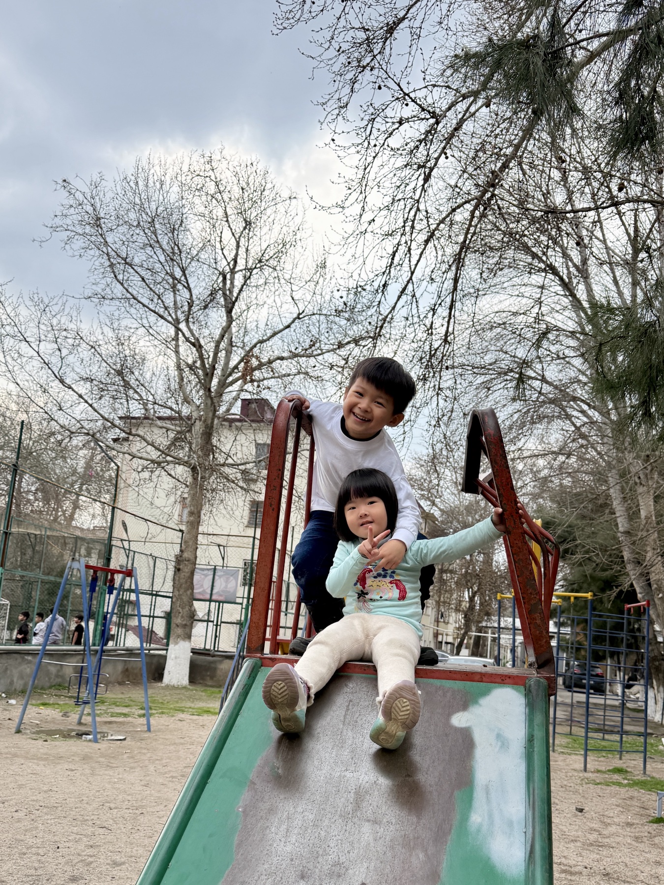 Sophie and George playing at a local playground outside Samarkand