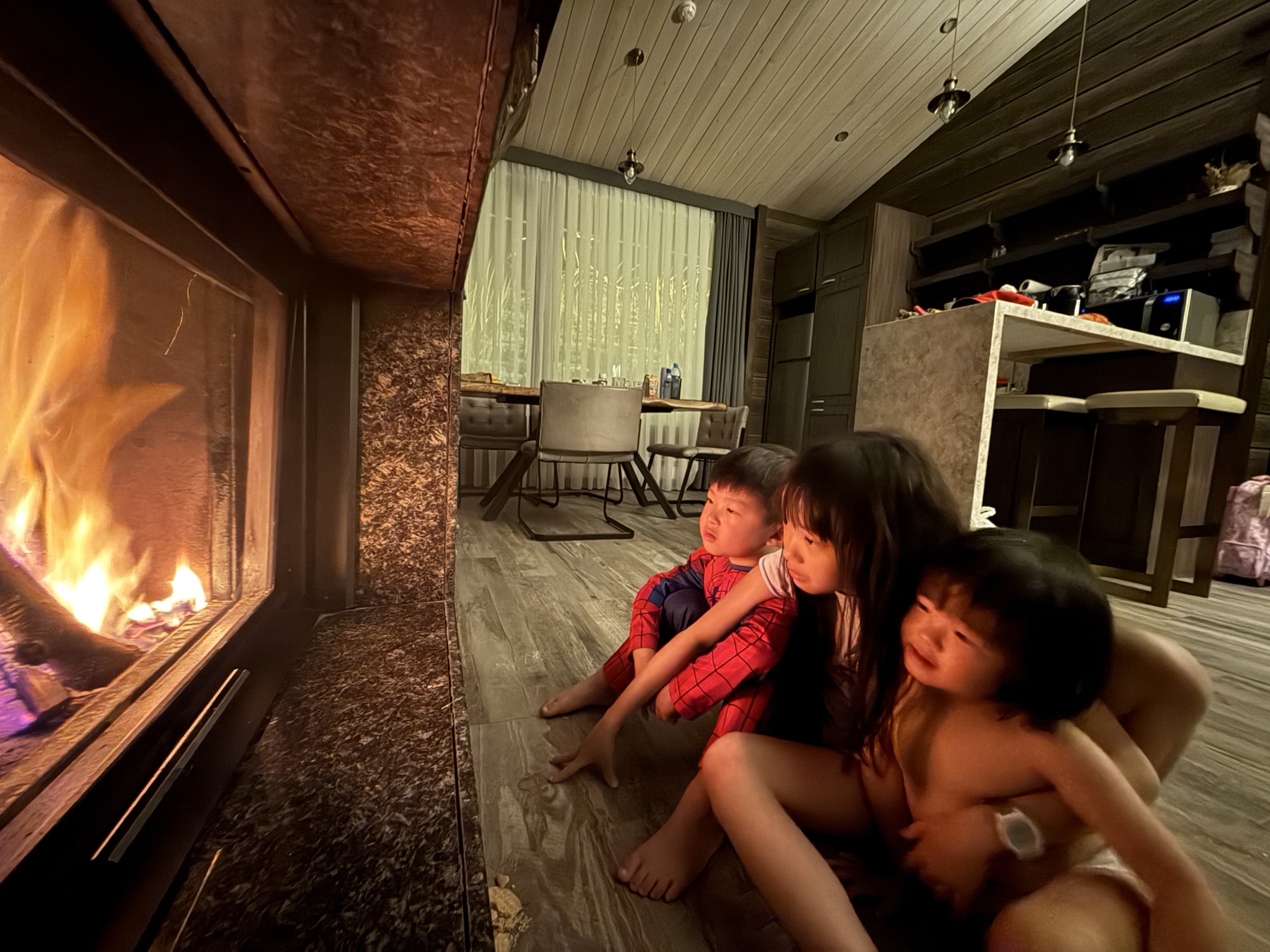 Children waiting beside a fire