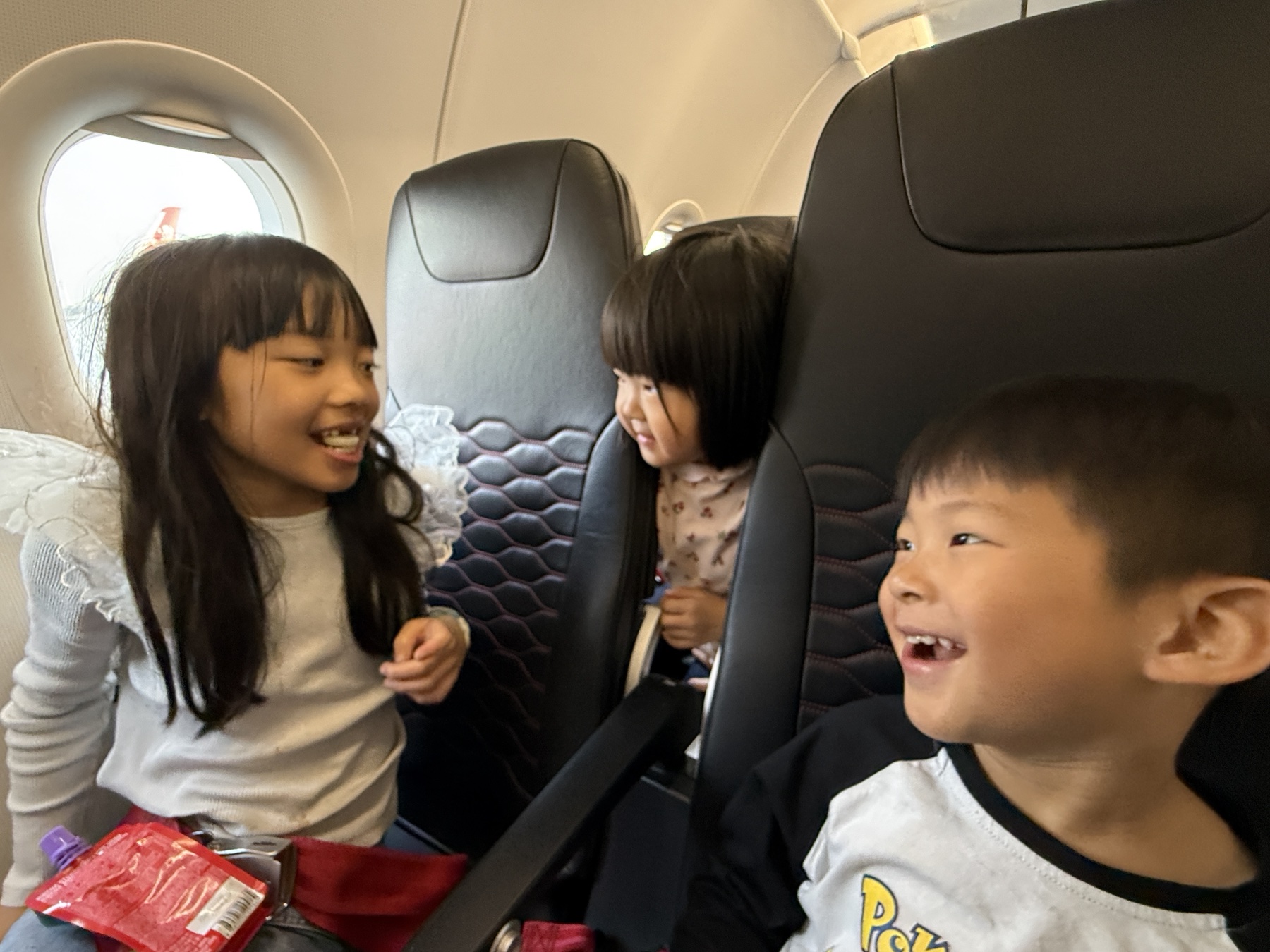 Children together on the flight home from Uzbekistan