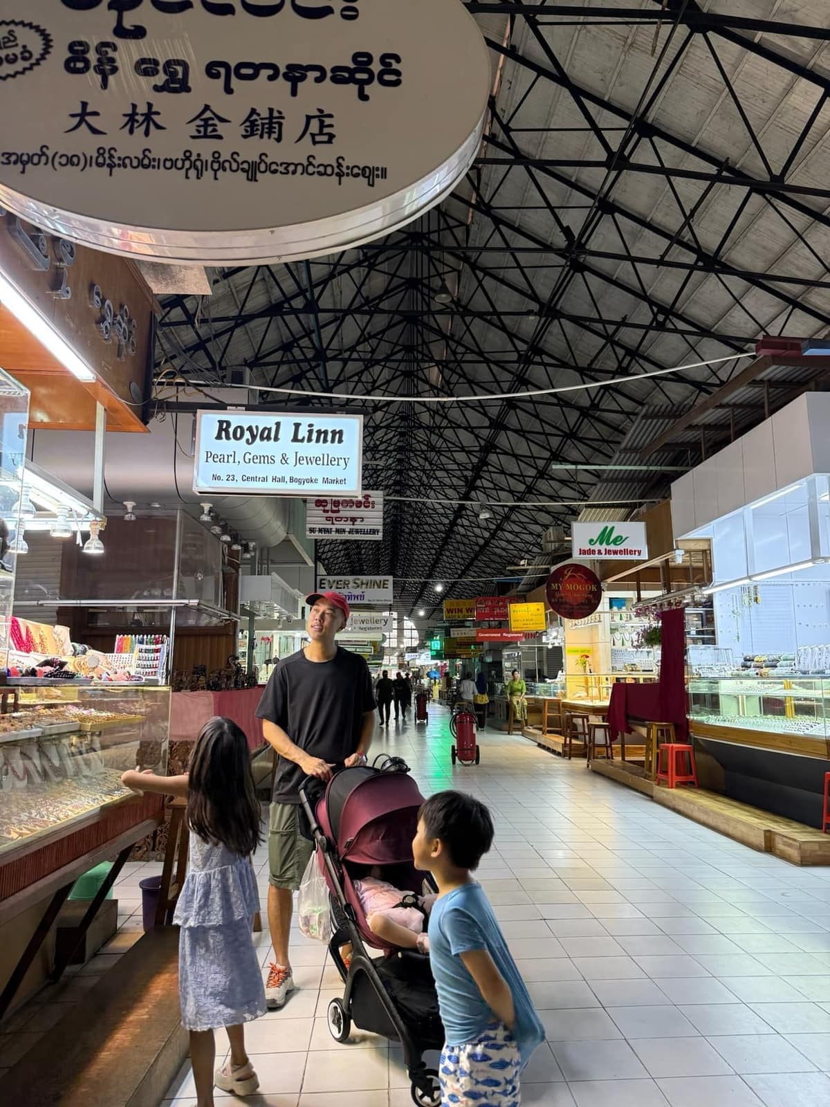 The family walking through the covered hall at Bogyoke Aung San Market