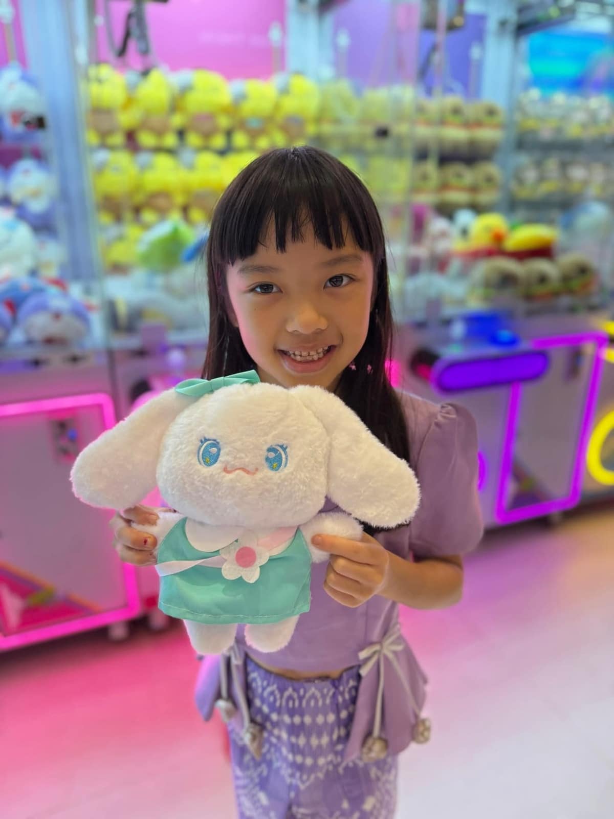 Sophie holding the soft toy she won from a claw machine in Yangon